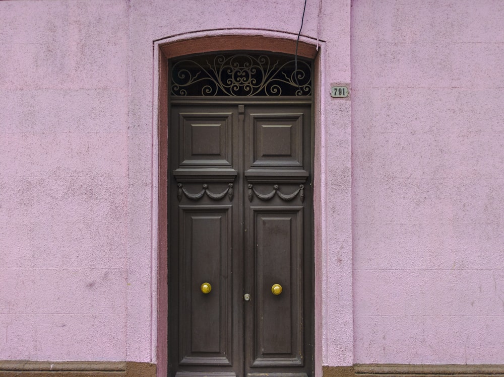 closed gray wooden door during daytime