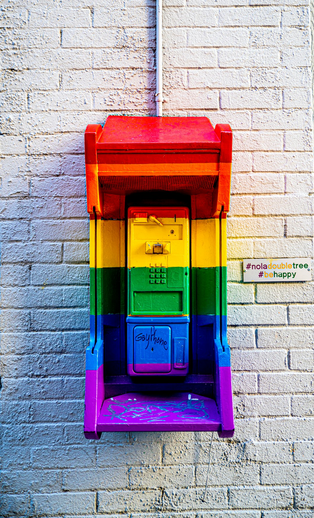 red, yellow, green, and purple payphone