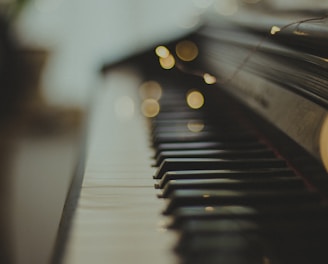 selective focus photography of black wooden piano keys