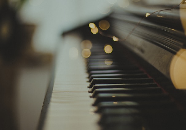 selective focus photography of black wooden piano keys