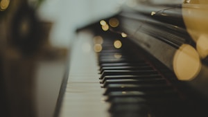 selective focus photography of black wooden piano keys