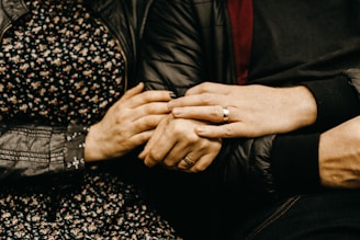 a close up of two people holding hands