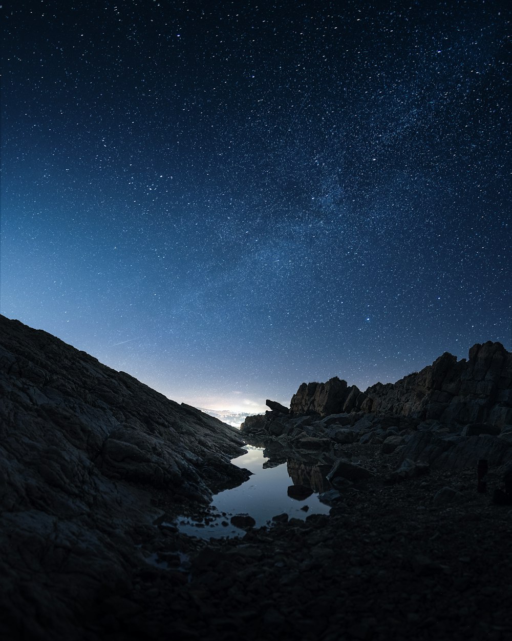 rocky valley under starry night