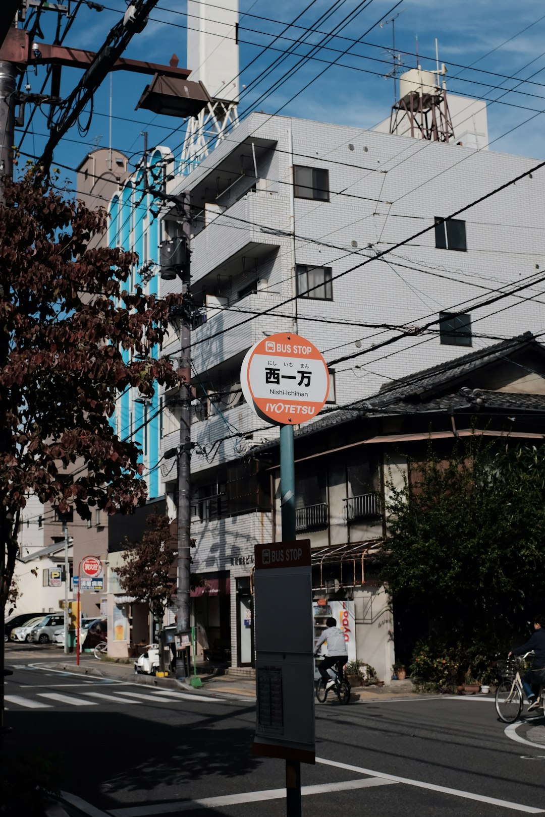 script-labeled road sign by concrete building