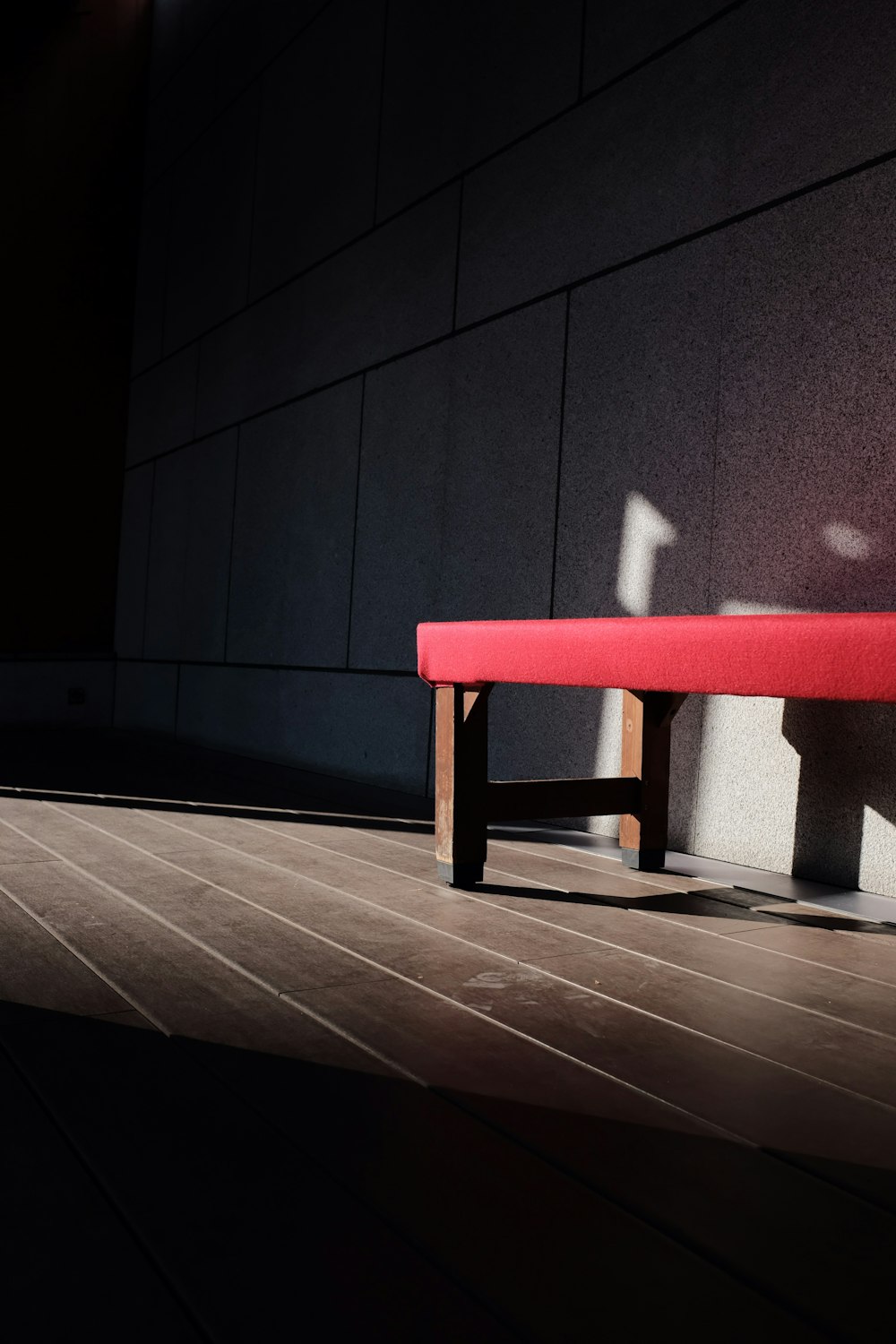 red bench by wall