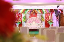 A vibrant kına night setup featuring a traditional kına throne and colorful decorations.