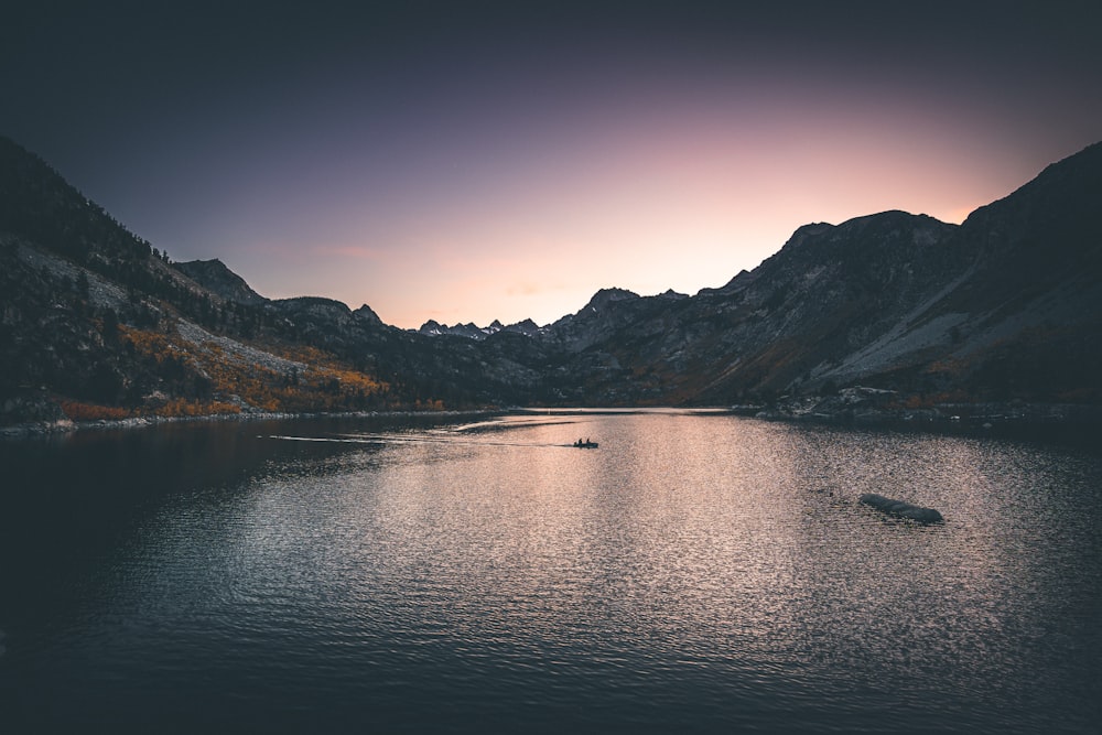 lake surround by mountain during nighttime