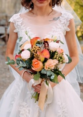 selective focus photography of bride holding flower bouquet