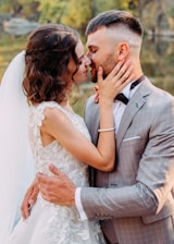 woman and man about to kiss by body of water