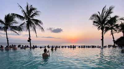 A poolside beach club scene at sunset, Seminyak, Bali