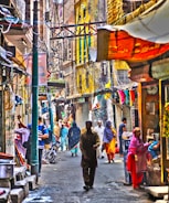 A bustling street in Aligarh lined with colorful local shops and cafes