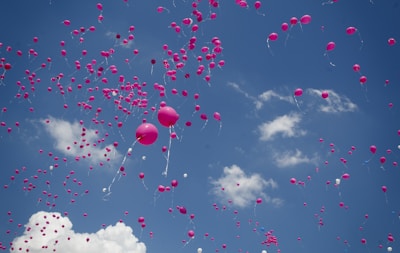 pink balloon lot on air during daytime