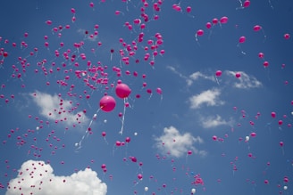 pink balloon lot on air during daytime