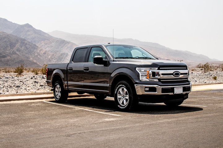 parked black crew-can pickup truck