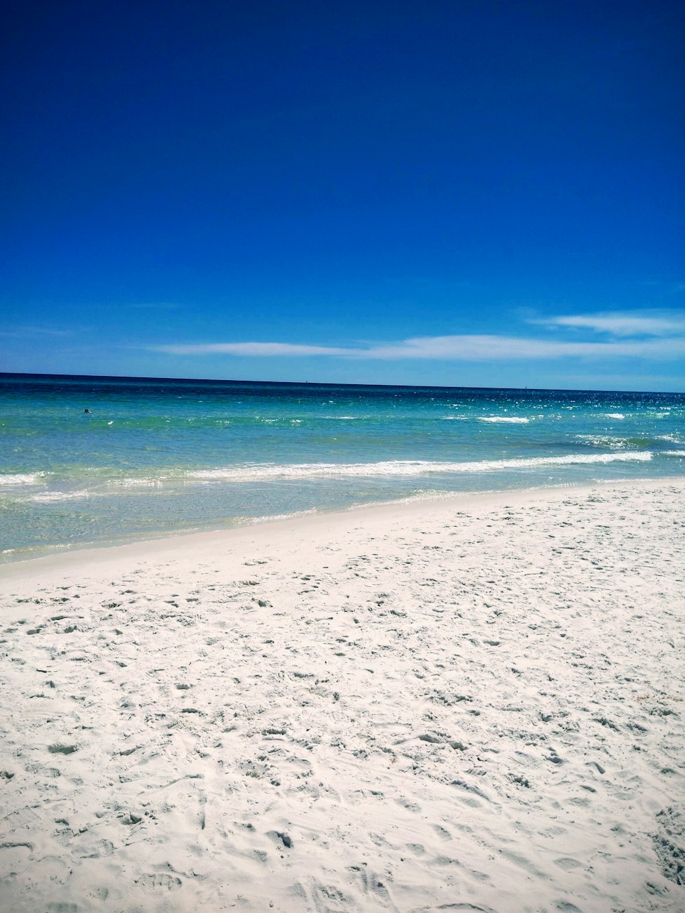 shore and ocean under blue sky