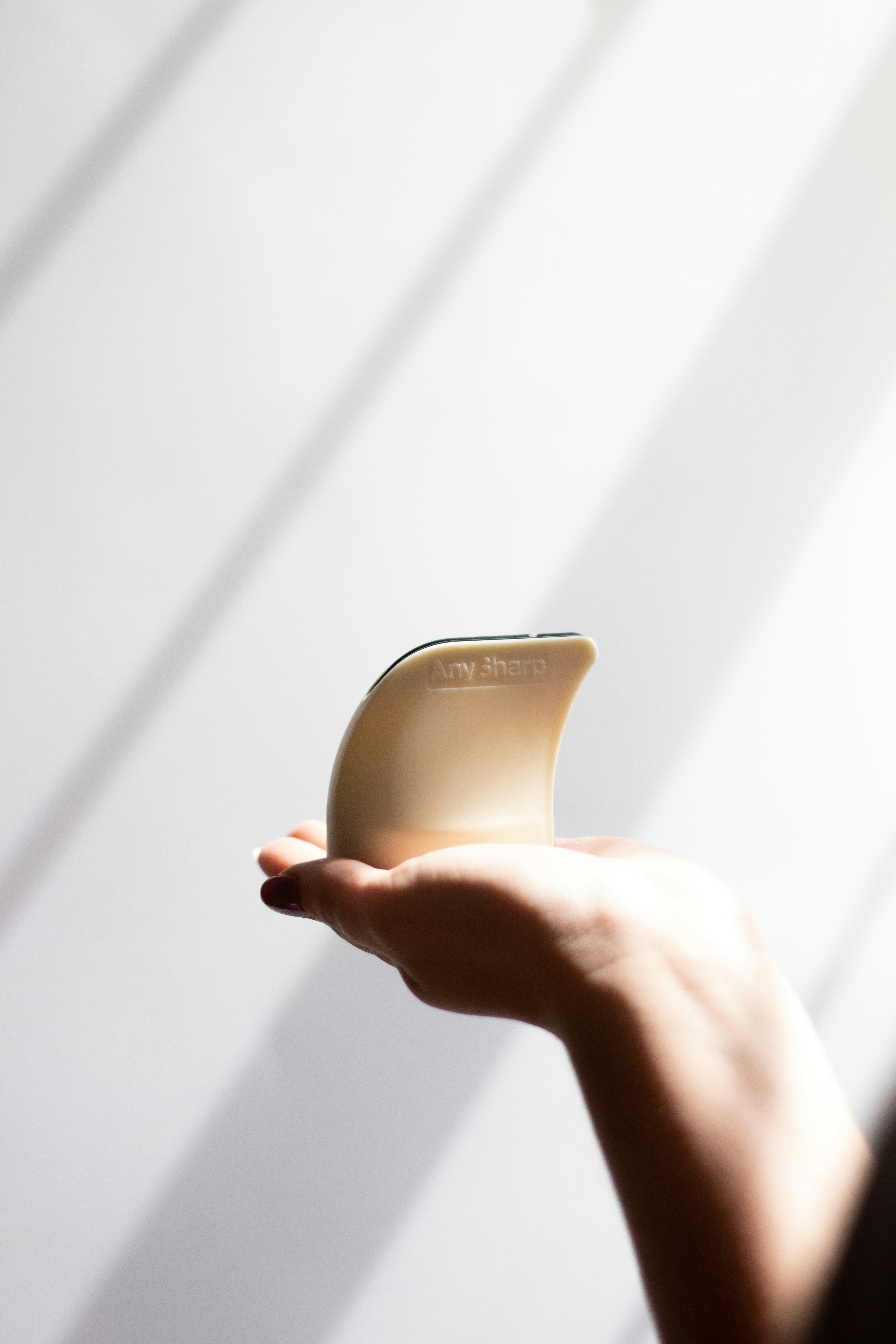 person holding brown case