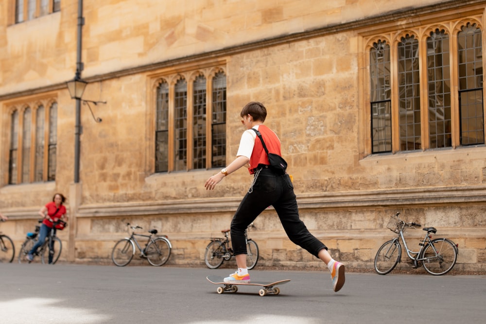 woman skateboarding beside wall