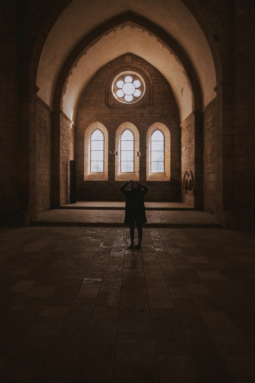 person standing near arch window building