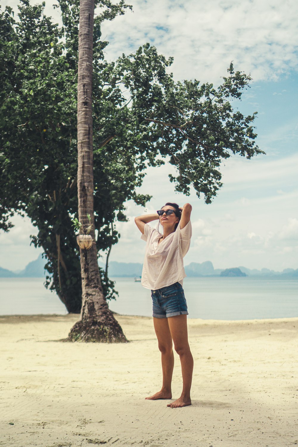 woman on shore near tree