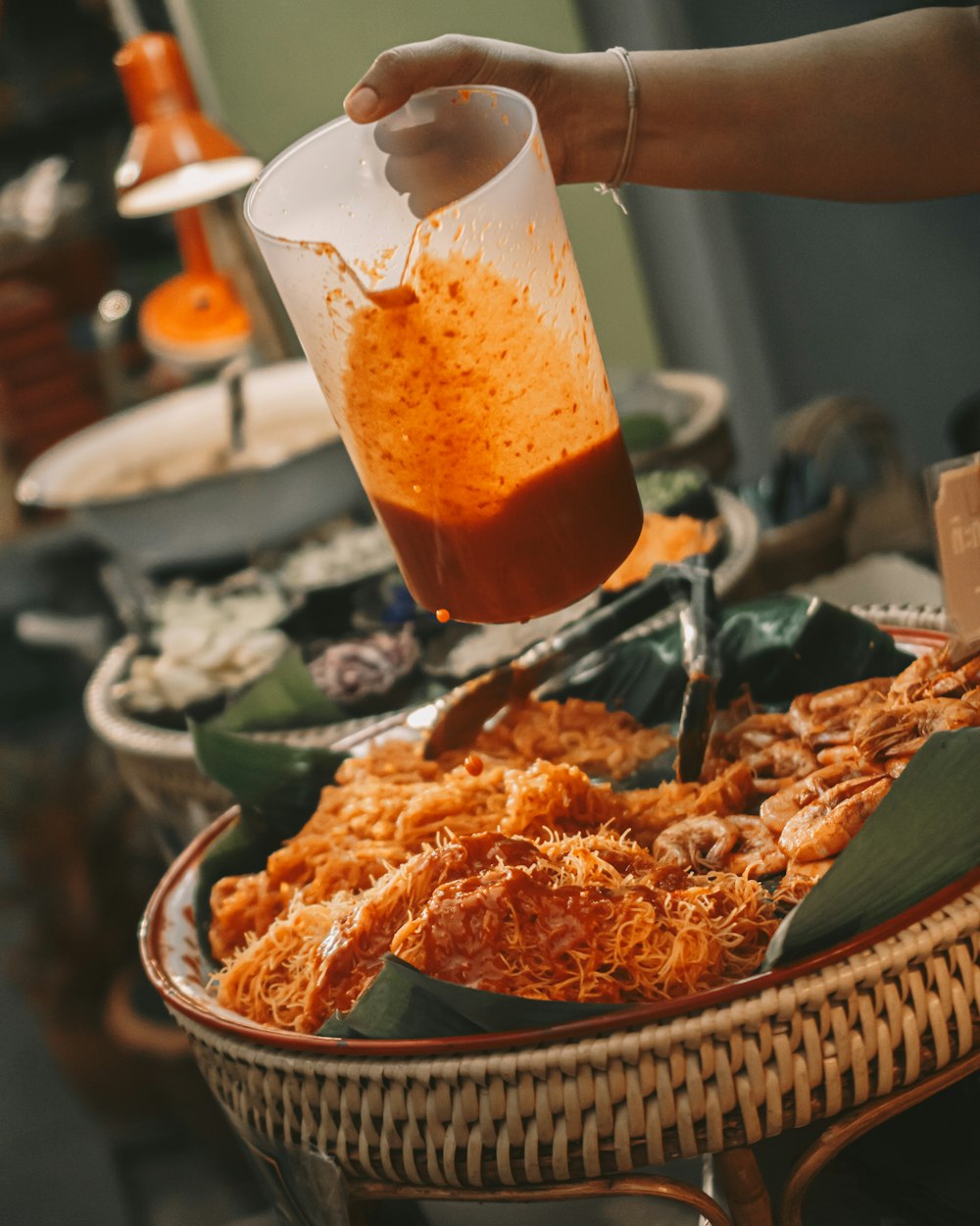 person holding sauce pitcher