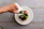 Close-up of a man savoring a homemade avocado sauce in a bright, natural setting.