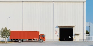red freight truck beside building
