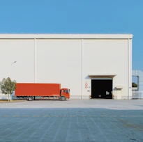 red freight truck beside building