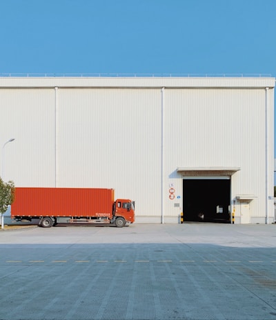 red freight truck beside building