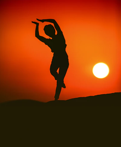 silhouette of person doing post during golden hour