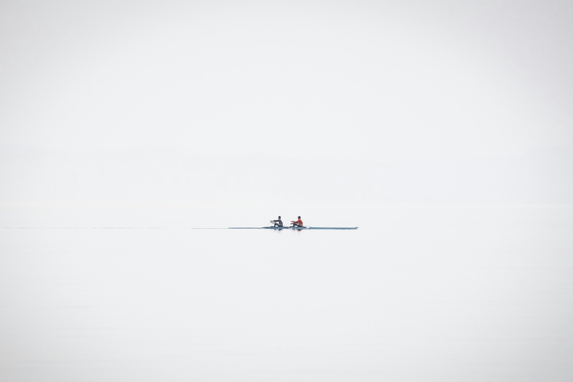 a couple of people riding on the back of a boat