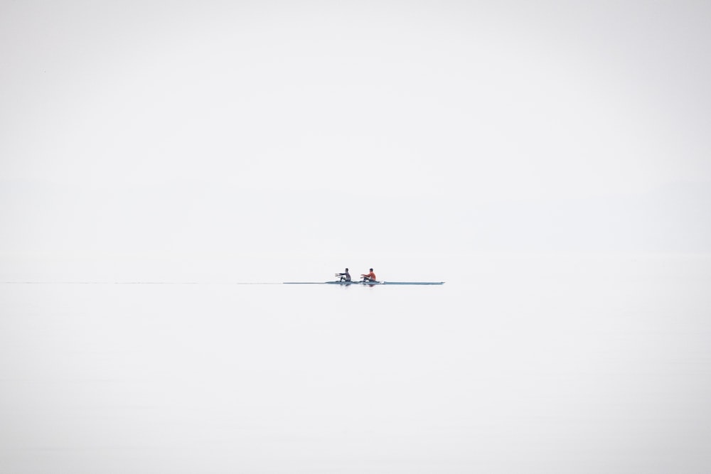 a couple of people riding on the back of a boat