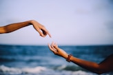 two person holding hands photograph