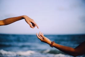 two person holding hands photograph