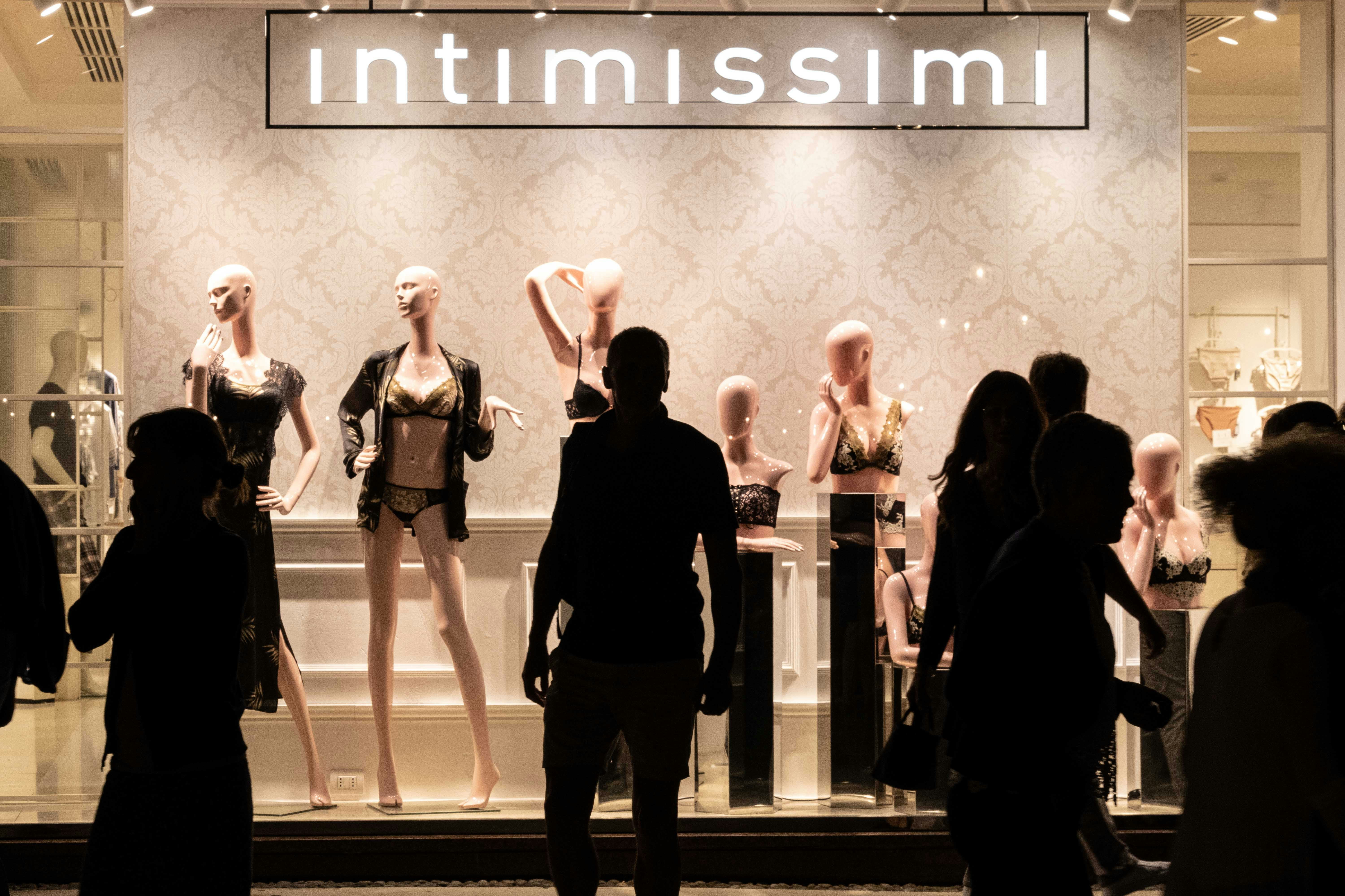 man standing near the Intimissimi store