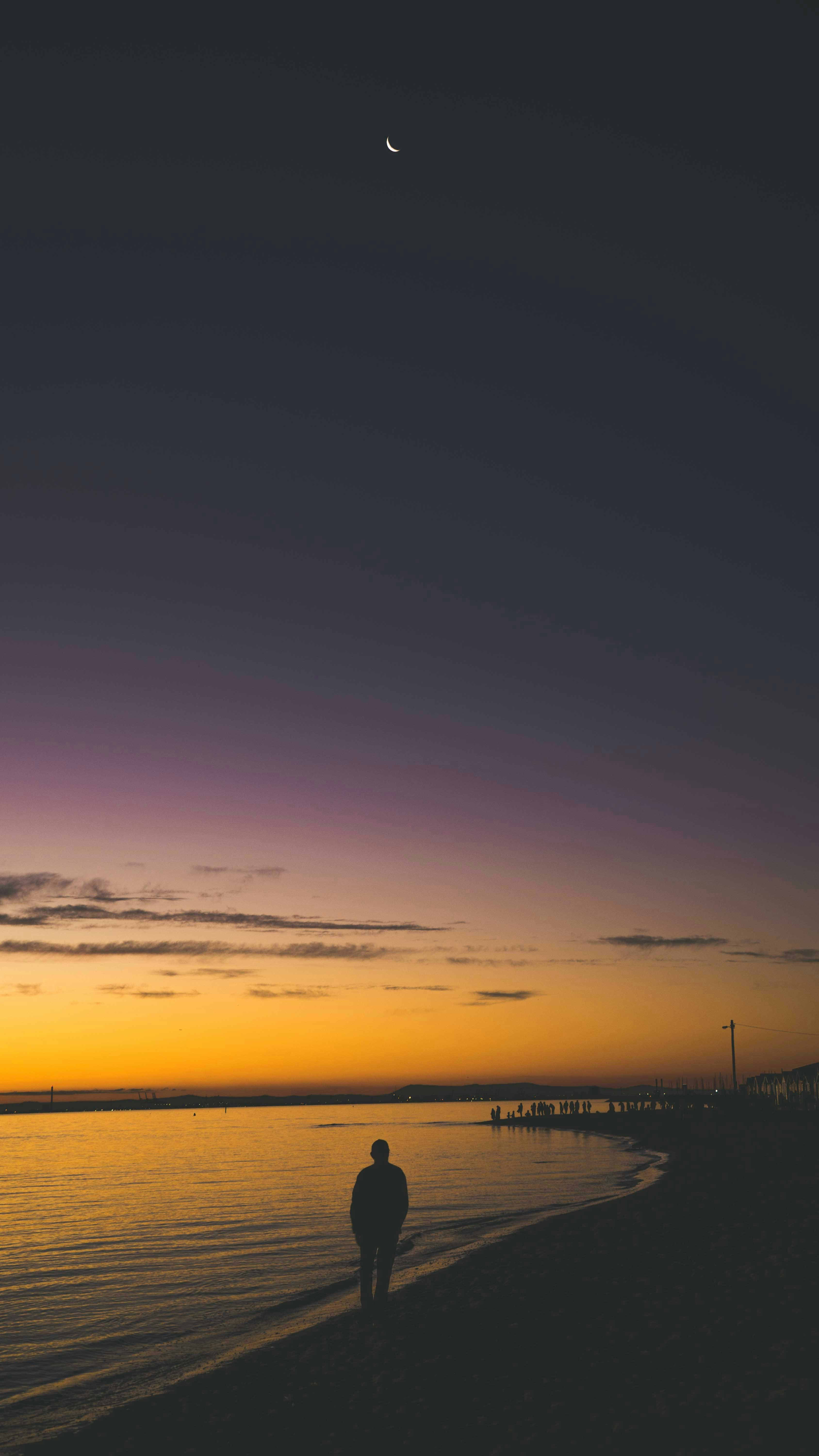 person walking on beach line