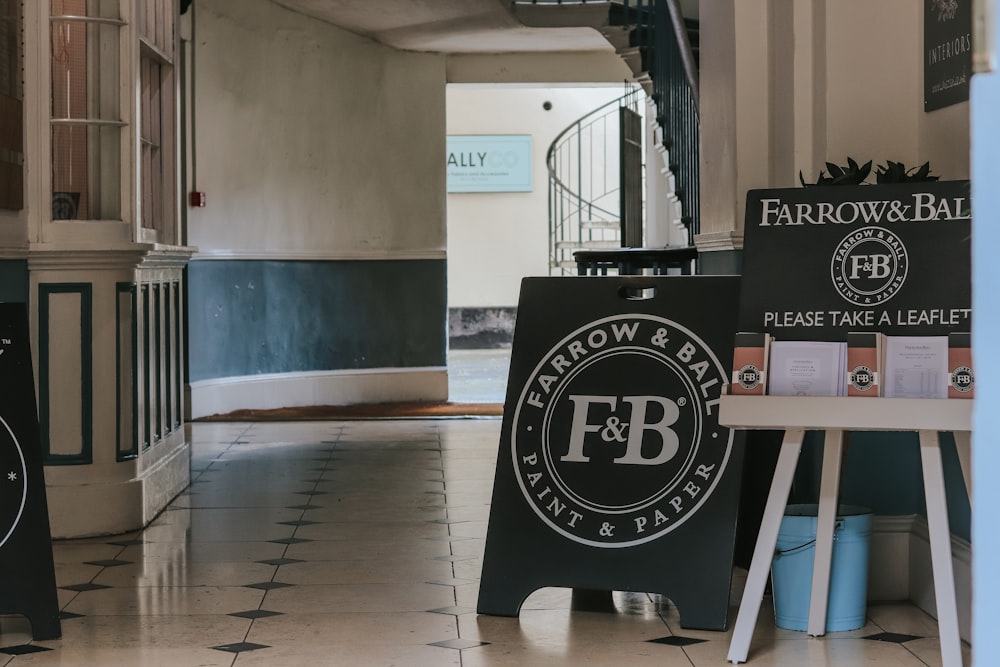 Farrow & Ball wooden signage leaning on wall inside building