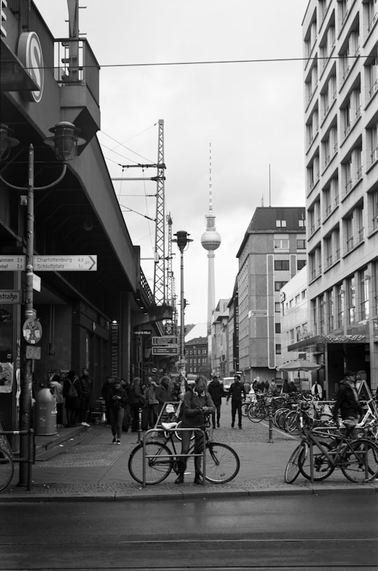 woman wearing jacket near the bicycle in Fernsehturm Berlin Germany