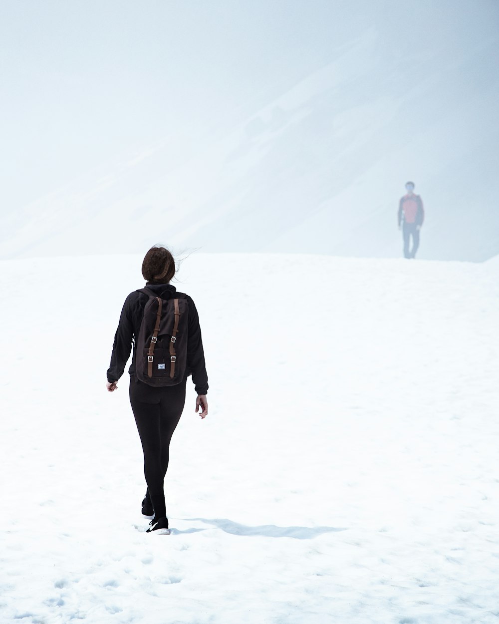 person walking on snow covered area