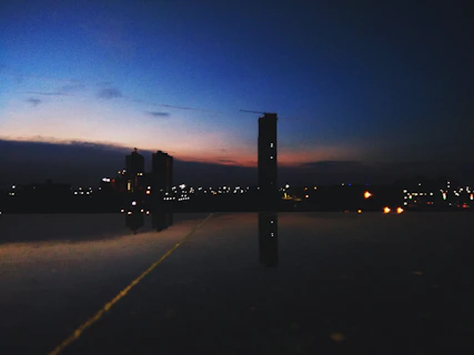 Vertical reel-style video thumbnail showing a dramatic cityscape at dusk with cinematic color grading.
