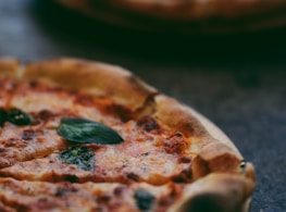 selective focus photography of two pizzas