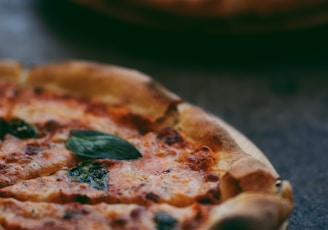 selective focus photography of two pizzas