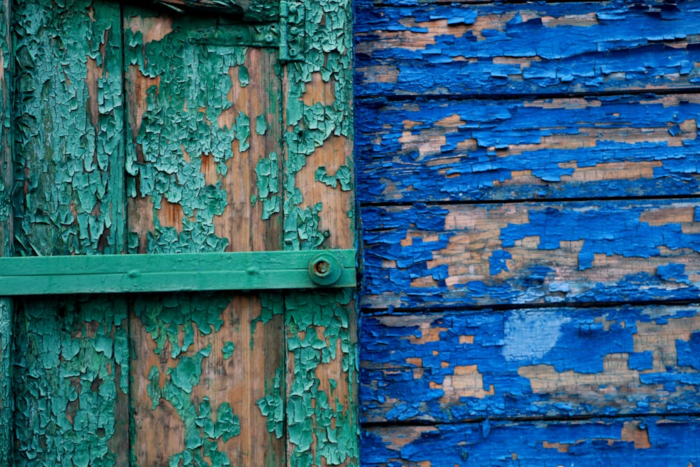 green wooden door and blue wall