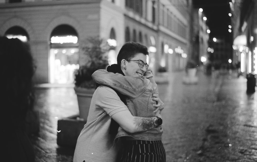 grayscale photography of man and woman embracing