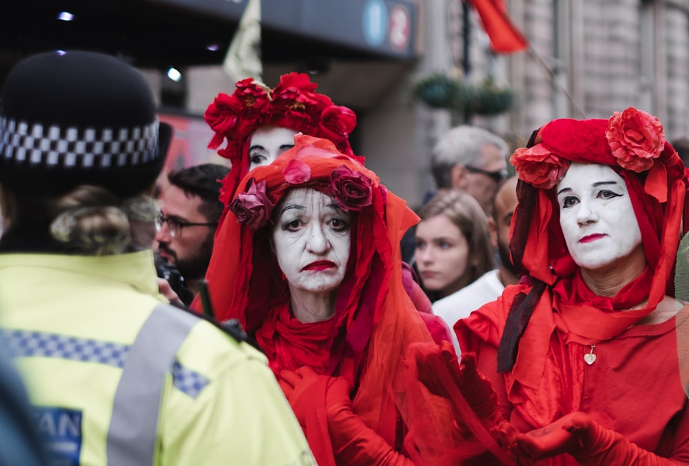 three women wearing red veils