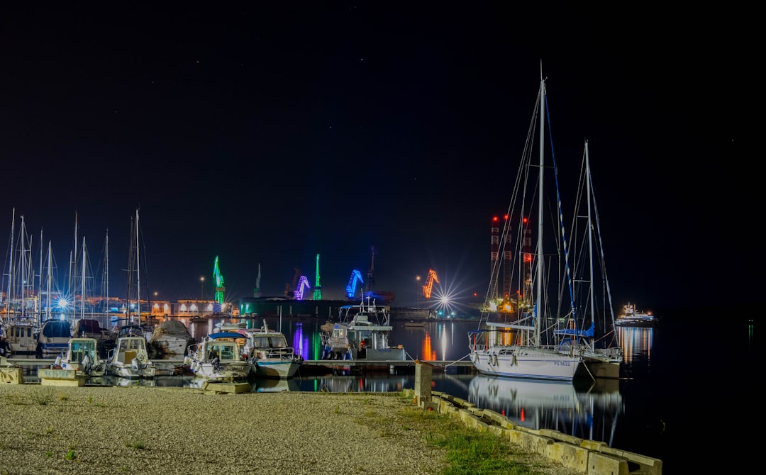 white boats and yachts on body of water during night time