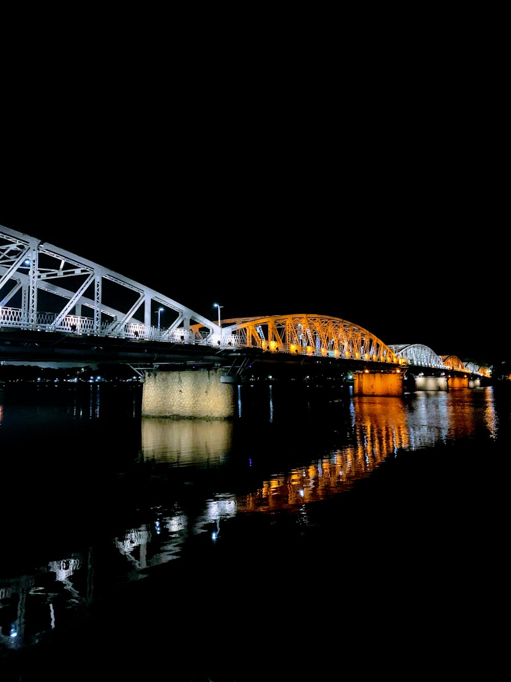 white and orange steel bridge during night time