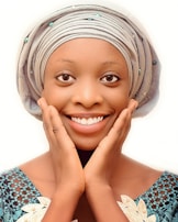 A client smiling with freshly done Senegalese twists accented by delicate lavender thread wraps.