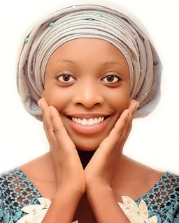 A client smiling with freshly done Senegalese twists accented by delicate lavender thread wraps.