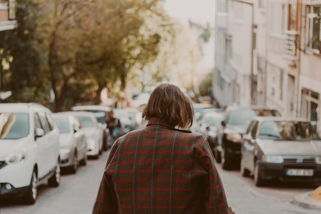 woman wears red and grey plaid dress shirt