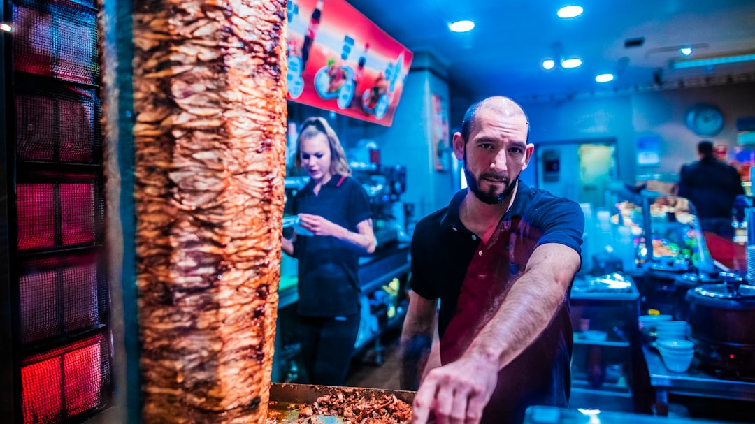 man standing near shawarma